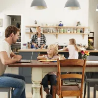 family sitting in kitchen